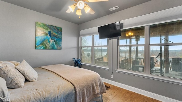 bedroom with hardwood / wood-style floors and ceiling fan