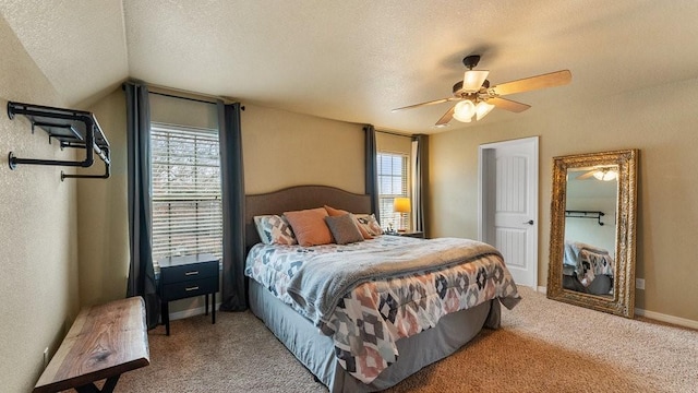 carpeted bedroom featuring multiple windows, ceiling fan, lofted ceiling, and a textured ceiling