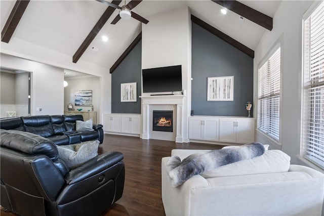 living room with ceiling fan, high vaulted ceiling, dark hardwood / wood-style floors, and beam ceiling