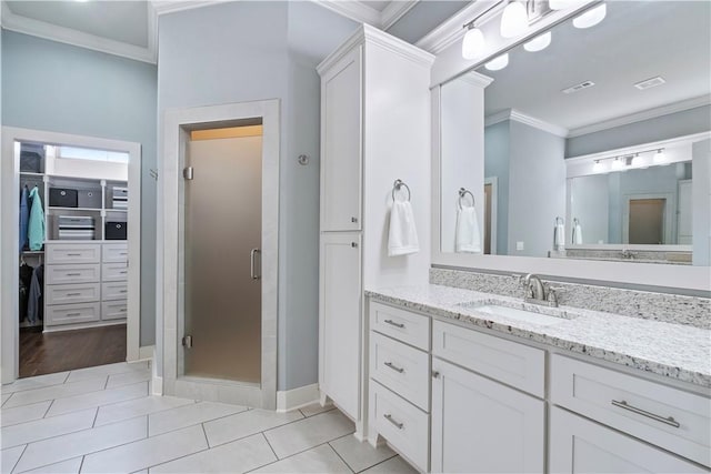 bathroom with ornamental molding, vanity, tile patterned floors, and a shower with shower door