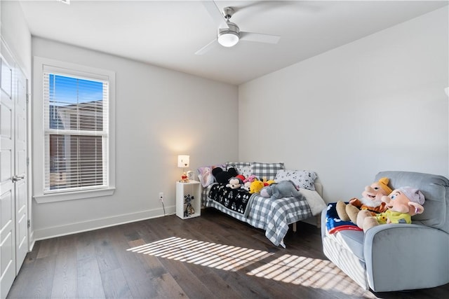 bedroom with dark hardwood / wood-style flooring and ceiling fan