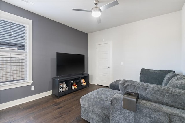 living room with dark wood-type flooring and ceiling fan