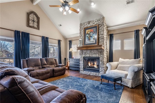 living room with ceiling fan, beam ceiling, high vaulted ceiling, a fireplace, and dark hardwood / wood-style flooring