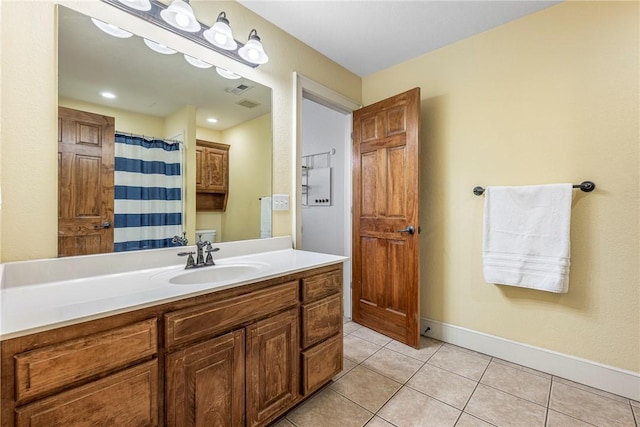 bathroom with tile patterned flooring, vanity, and curtained shower