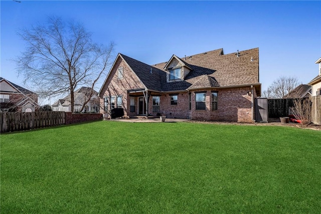 rear view of property featuring a lawn