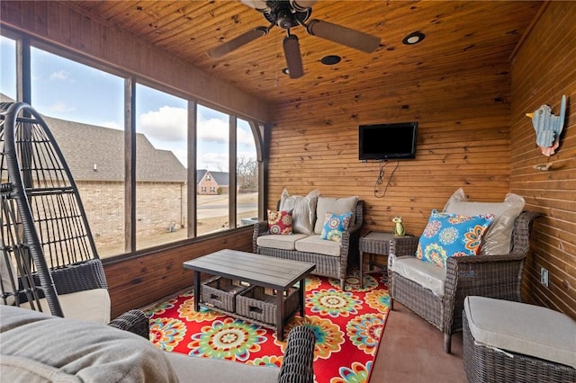 sunroom featuring ceiling fan and wood ceiling