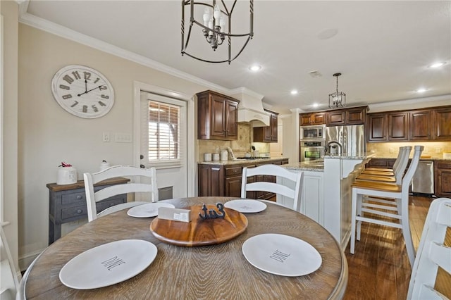 dining area featuring a notable chandelier, crown molding, and dark wood-type flooring