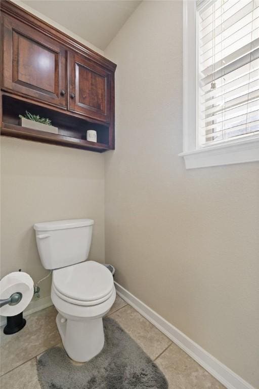 bathroom featuring vaulted ceiling, toilet, and tile patterned flooring