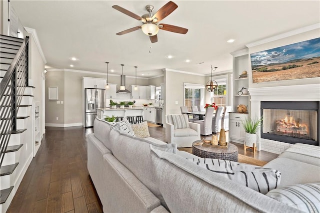 living room with dark hardwood / wood-style flooring, ornamental molding, and ceiling fan