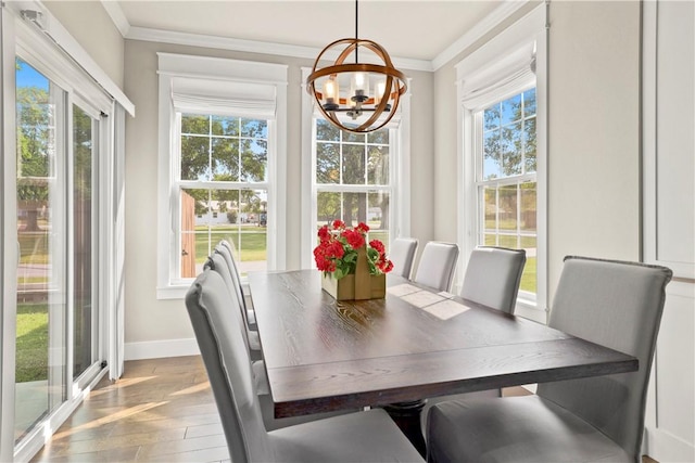 sunroom featuring plenty of natural light and an inviting chandelier