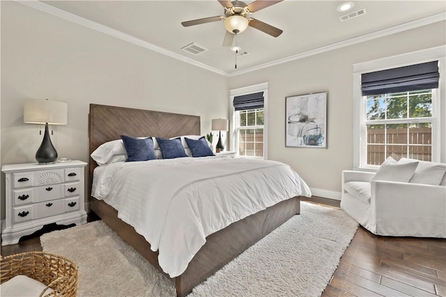 bedroom featuring crown molding, dark wood-type flooring, and ceiling fan