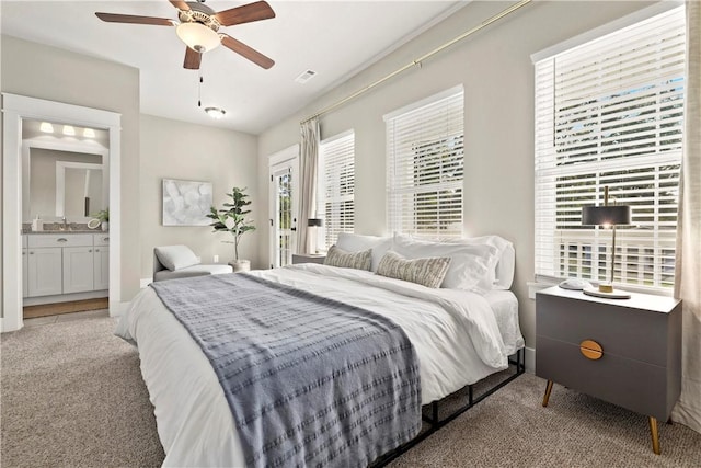 bedroom with carpet, sink, connected bathroom, and ceiling fan