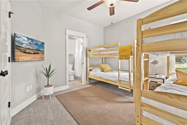 bedroom with connected bathroom, ceiling fan, and carpet