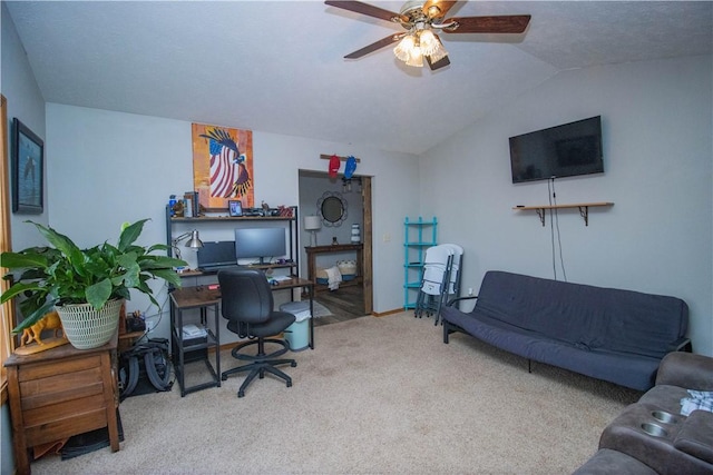 carpeted office space featuring vaulted ceiling and ceiling fan