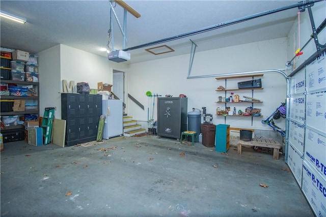 garage featuring white refrigerator and a garage door opener