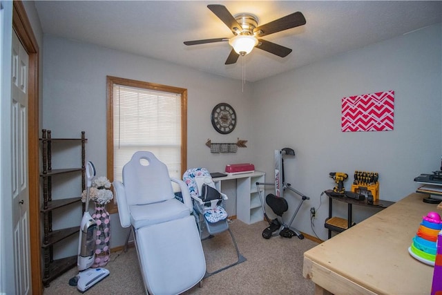 carpeted home office with ceiling fan