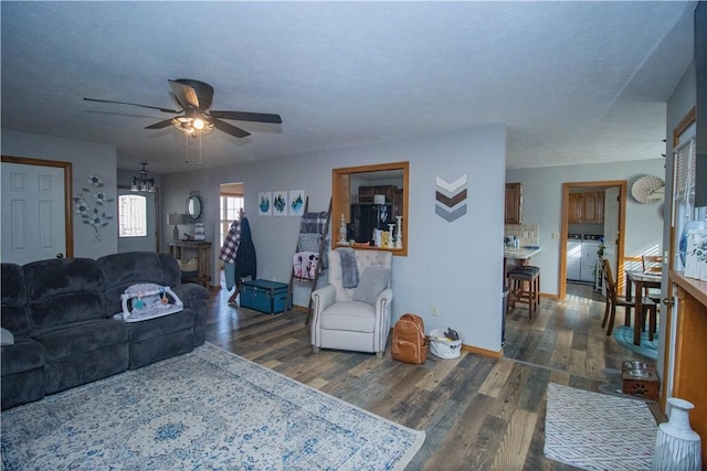 living room featuring dark hardwood / wood-style flooring and ceiling fan