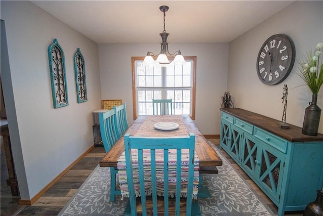 dining room featuring an inviting chandelier and dark hardwood / wood-style floors