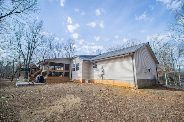 back of property with a sunroom