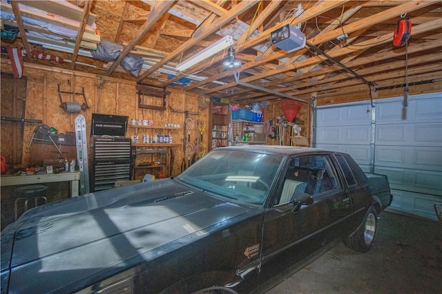 garage with a garage door opener and a workshop area