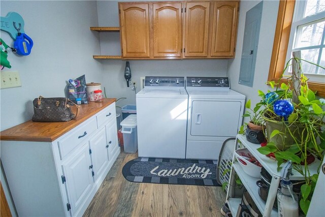 clothes washing area with cabinets, dark hardwood / wood-style flooring, and separate washer and dryer