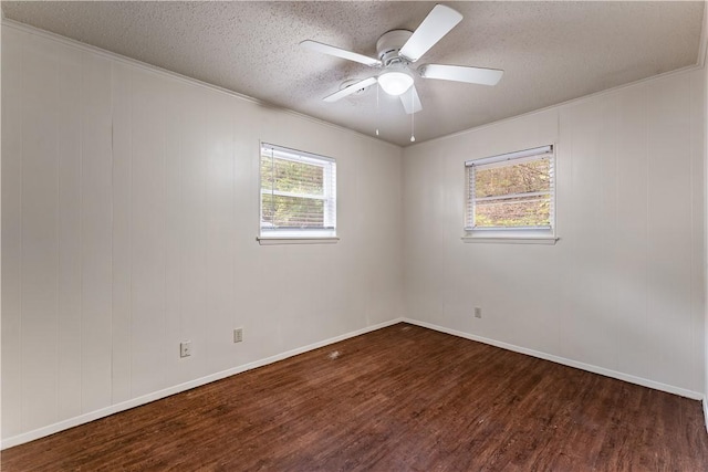 unfurnished room featuring dark hardwood / wood-style flooring, a textured ceiling, crown molding, and ceiling fan