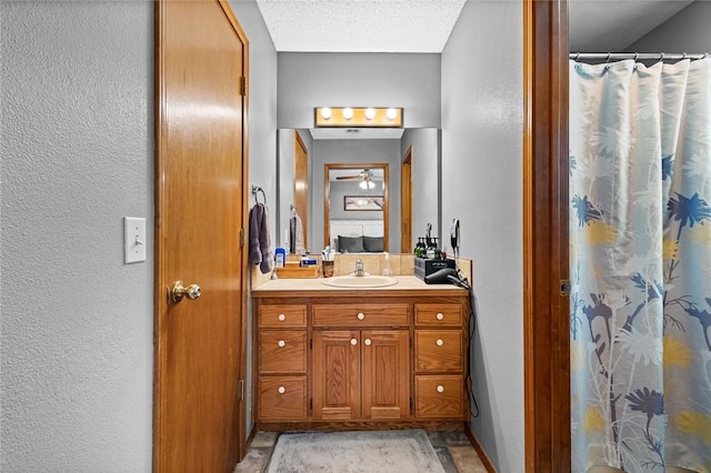 bathroom with vanity, a textured ceiling, and walk in shower