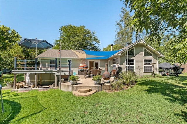 back of property featuring a yard and a patio