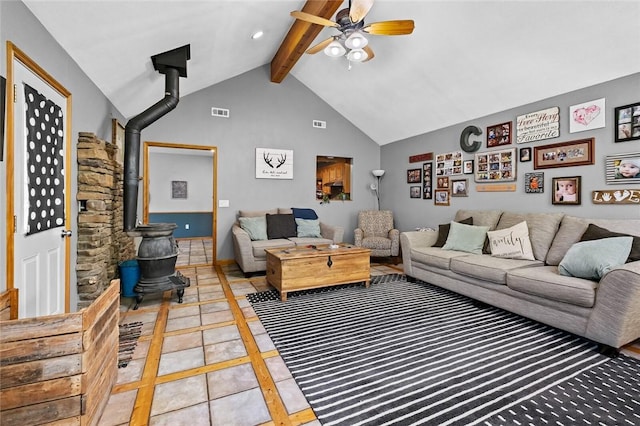 living room featuring beam ceiling, high vaulted ceiling, ceiling fan, and a wood stove