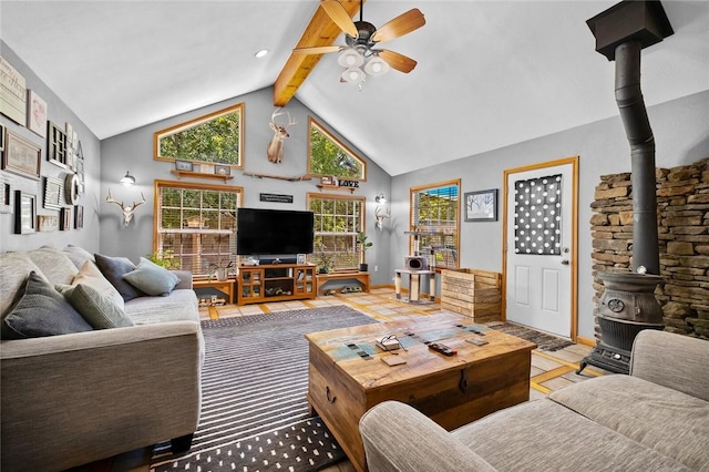 living room featuring beamed ceiling, high vaulted ceiling, a wood stove, and ceiling fan