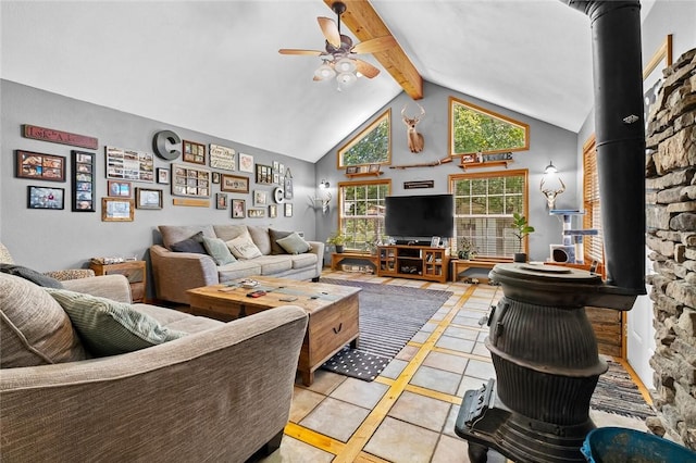 living room featuring ceiling fan, beam ceiling, high vaulted ceiling, light tile patterned flooring, and a wood stove