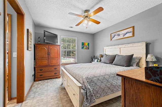 bedroom featuring ceiling fan and a textured ceiling