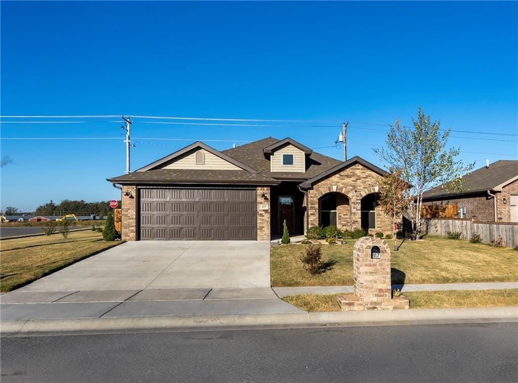 view of front of property featuring a garage and a front yard