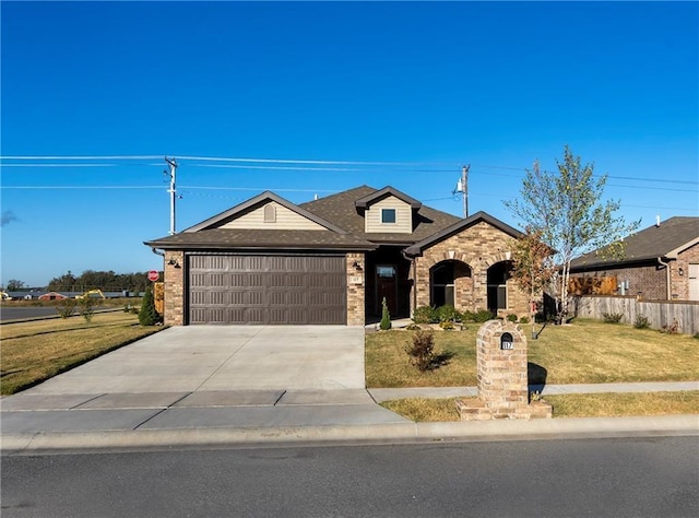 view of front of property featuring a garage and a front yard