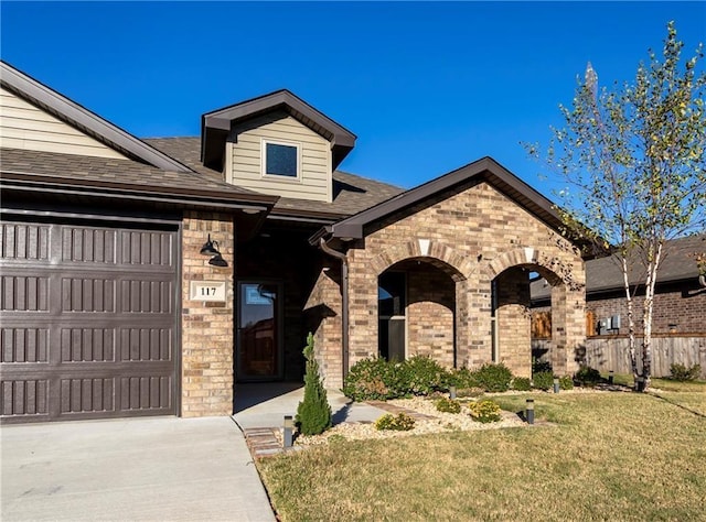 view of front of home with a garage and a front yard