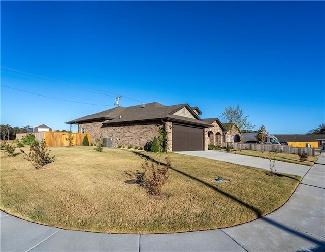 view of front of house featuring a garage and a front lawn