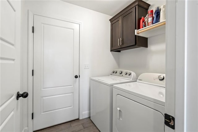 laundry room featuring cabinets, washer and clothes dryer, and light hardwood / wood-style floors