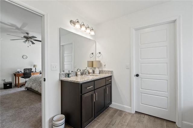 bathroom with ceiling fan, vanity, and hardwood / wood-style floors