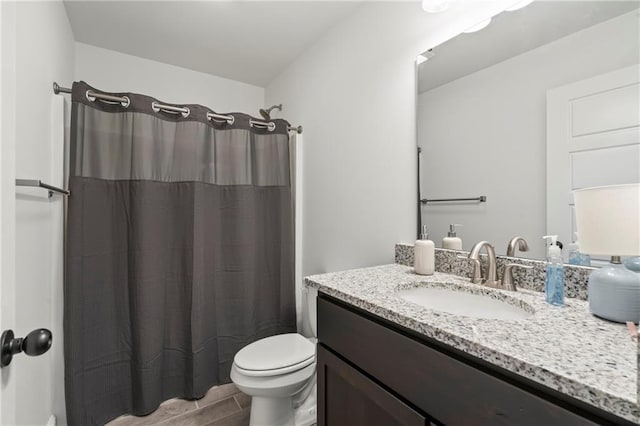 bathroom with vanity, walk in shower, and toilet