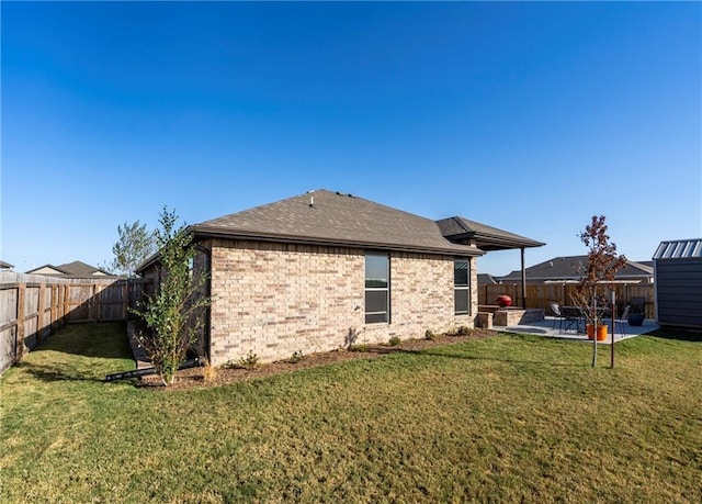 rear view of property with a patio and a lawn