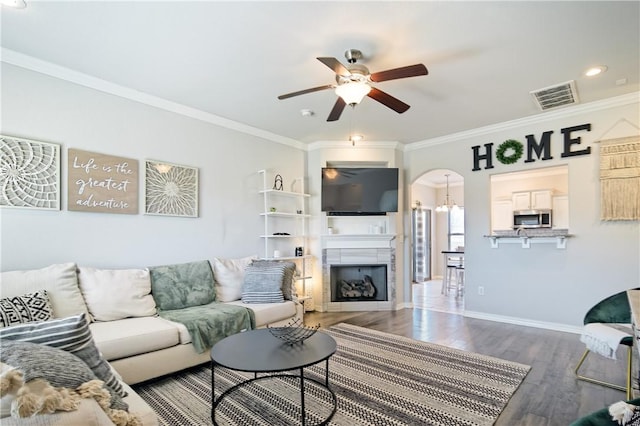 living room with crown molding, hardwood / wood-style flooring, and ceiling fan