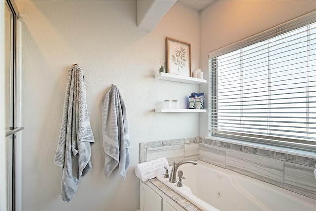 bathroom with a healthy amount of sunlight and a bath