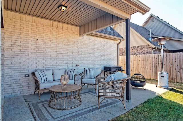 view of patio with an outdoor living space with a fire pit