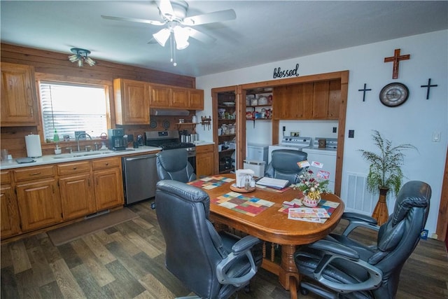 kitchen with appliances with stainless steel finishes, sink, dark hardwood / wood-style flooring, washing machine and clothes dryer, and ceiling fan