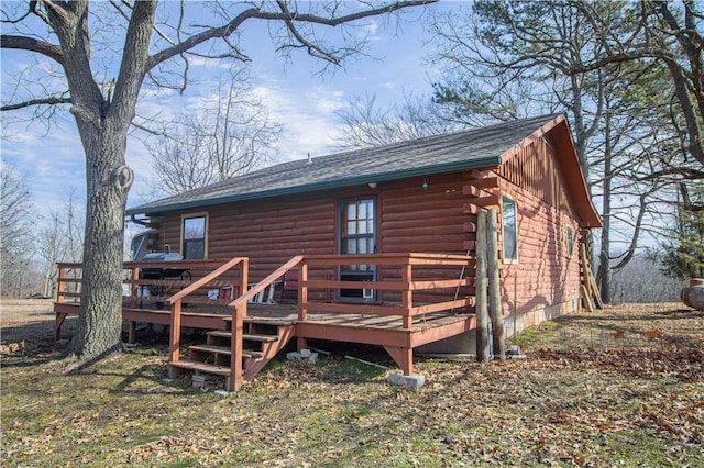 back of house with a deck