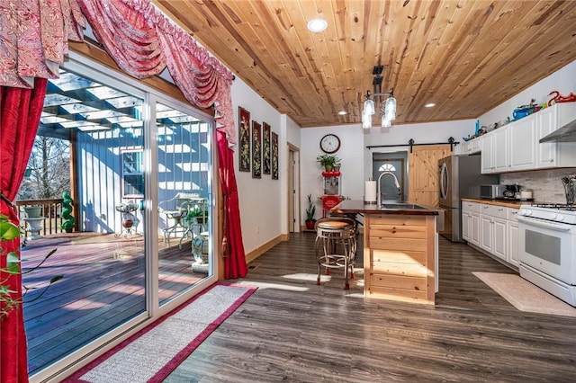 kitchen featuring white cabinetry, a breakfast bar area, white range with gas stovetop, wood ceiling, and a barn door