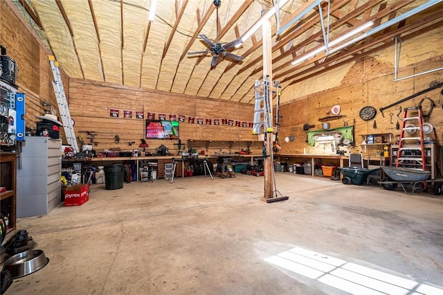 garage featuring ceiling fan and a workshop area