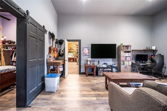 living room with hardwood / wood-style flooring and a barn door