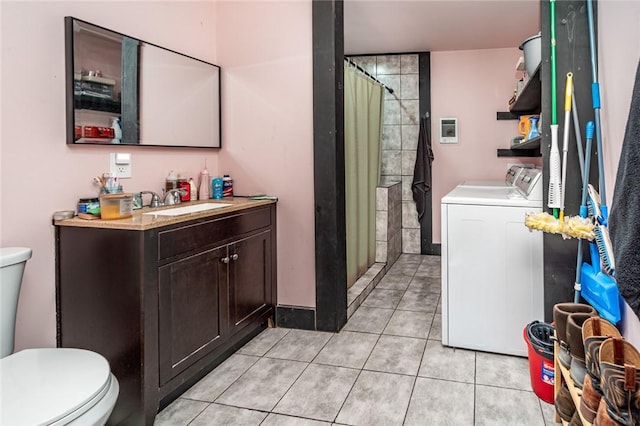 laundry area with light tile patterned flooring, sink, and independent washer and dryer