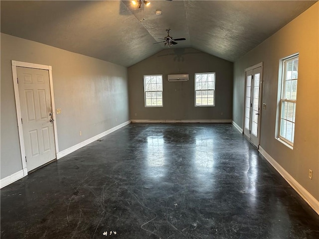 unfurnished living room featuring ceiling fan, lofted ceiling, and a wall unit AC